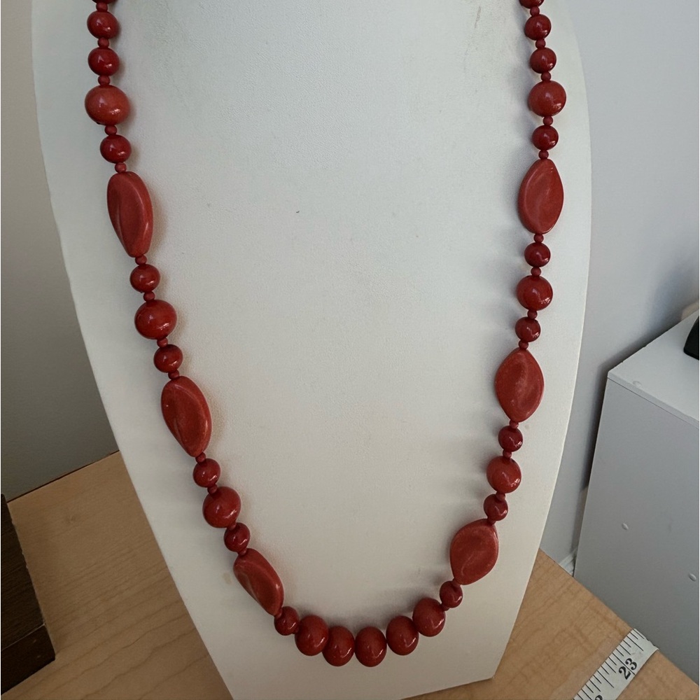 Red beaded necklace with graduated sizes/ silver tone/ lobster clasp
